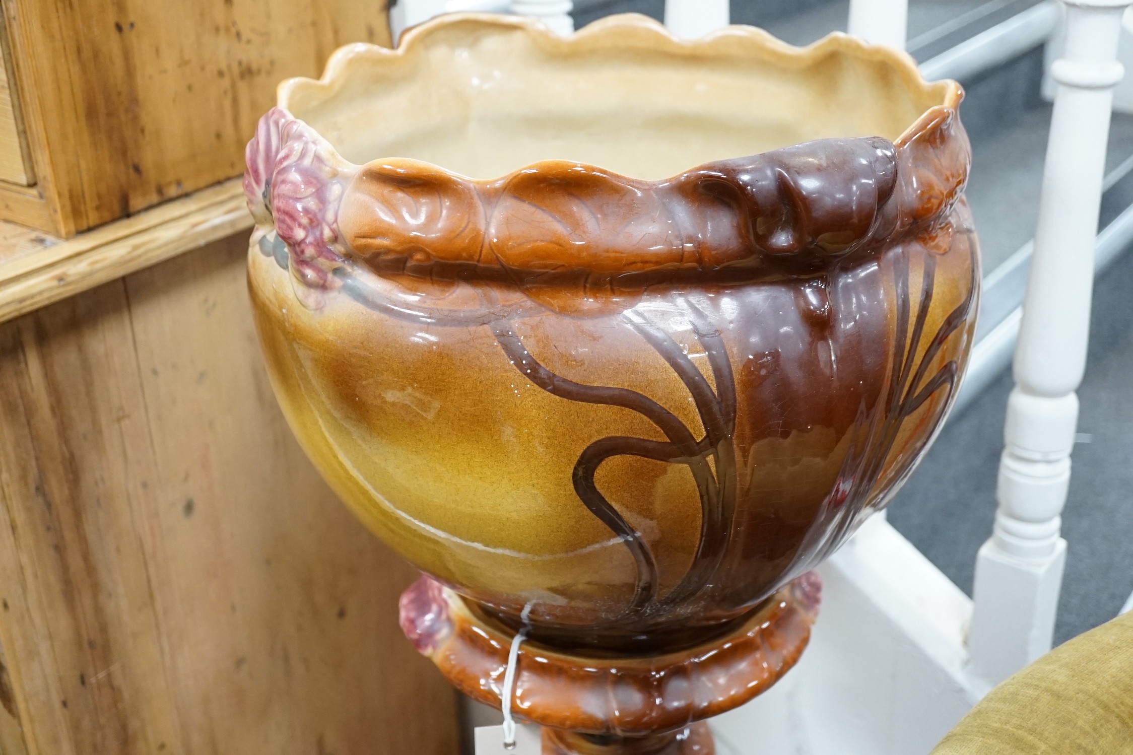 An Art Nouveau style earthenware jardiniere on pedestal. 93cm tall